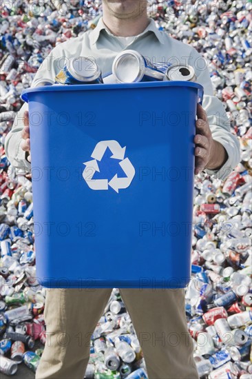 Man holding blue bin.