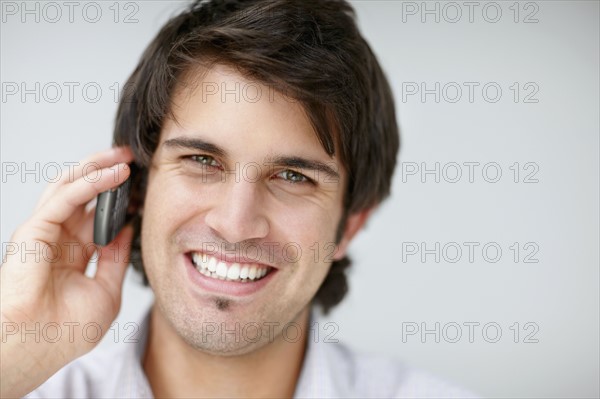 Handsome man talking on cell phone. Photo : momentimages