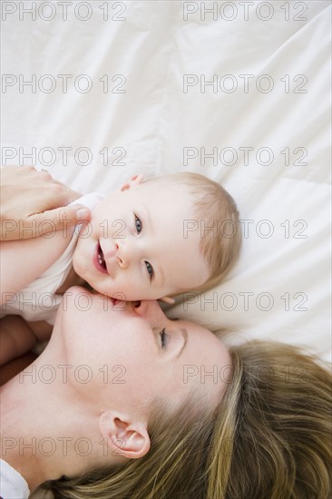 Mother and baby lying down together. Photo : Jamie Grill