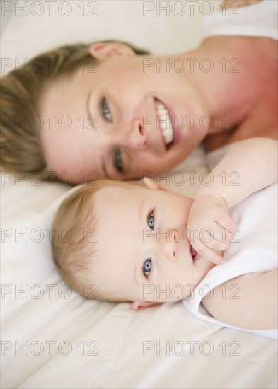 Mother and baby lying down together. Photo. Jamie Grill