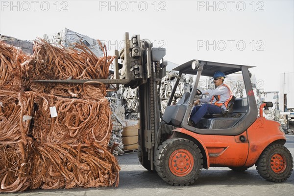 Forklift driver working at recycling plant.
