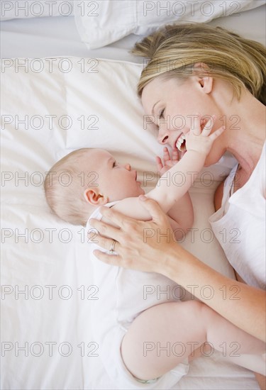 Mother and baby lying down together. Photo. Jamie Grill