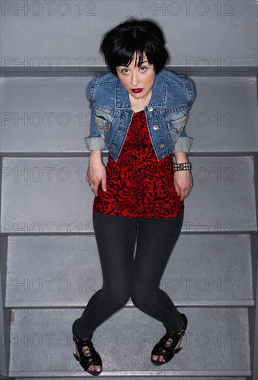 Woman sitting on stairs. Photo. Daniel Grill