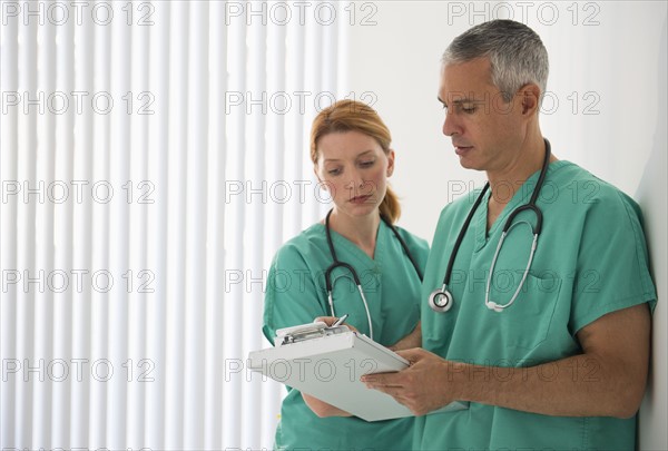 Healthcare professionals looking at medical chart.