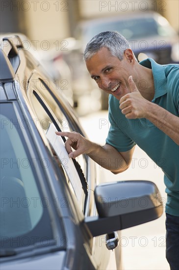 Man looking at new car.