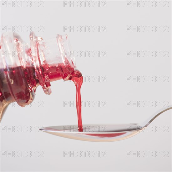 Cough syrup being poured onto spoon. Photo. Jamie Grill