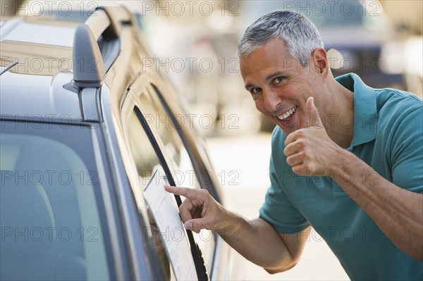 Man looking at new car.