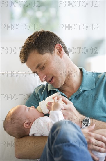 Father feeding his baby.