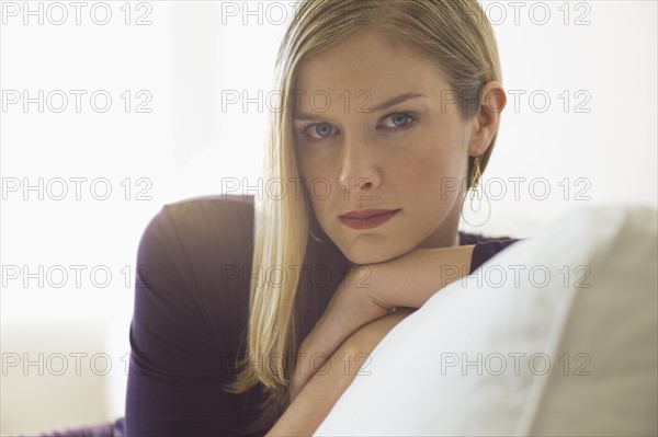 Sophisticated woman relaxing on couch.