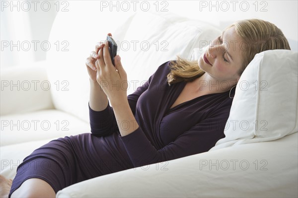 Sophisticated woman relaxing on couch.