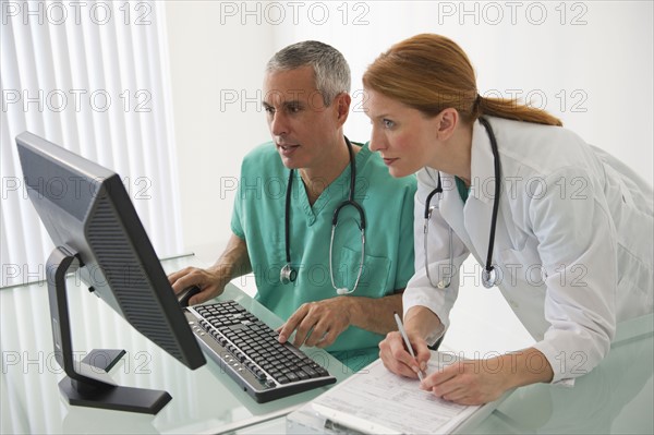 Healthcare professionals looking at computer.