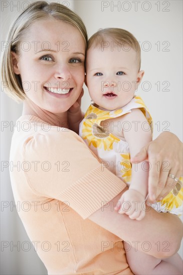 Mother holding her baby daughter. Photo : Jamie Grill