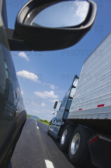 Truck and car on highway.