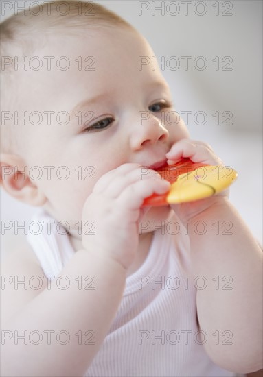Baby sucking on teething toy. Photo : Jamie Grill