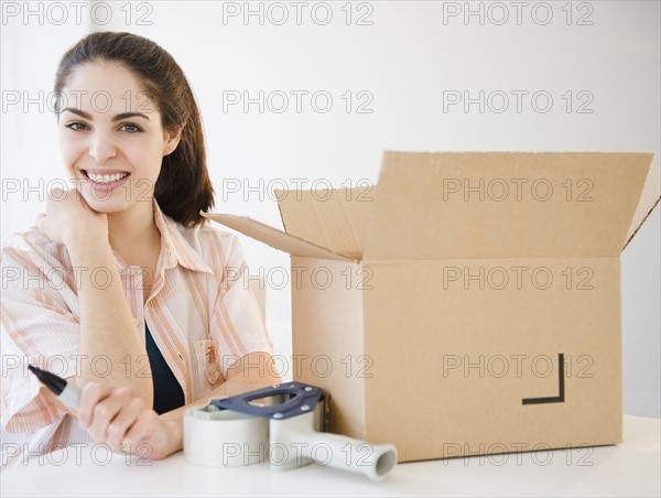Woman packing boxes. Photo. Jamie Grill