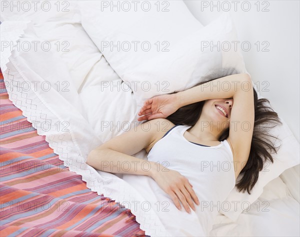 Woman lying in bed. Photo : Jamie Grill