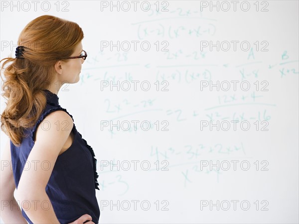 Woman doing math equations. Photo. Jamie Grill