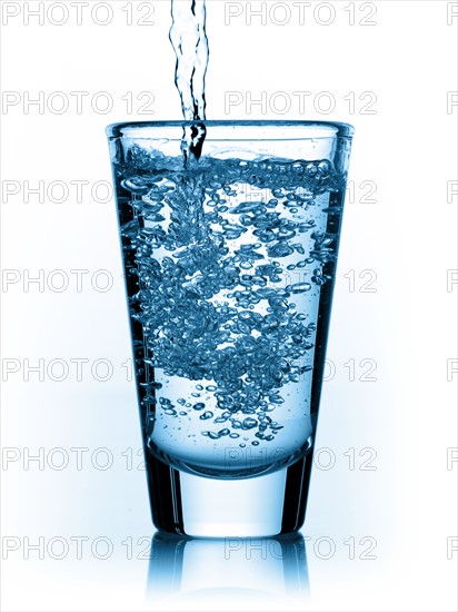 Water being poured in glass. Photo : David Arky