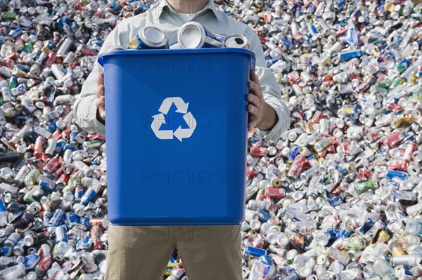 Man holding blue bin.