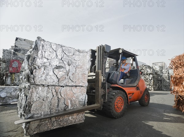 Forklift driver at recycling plant.