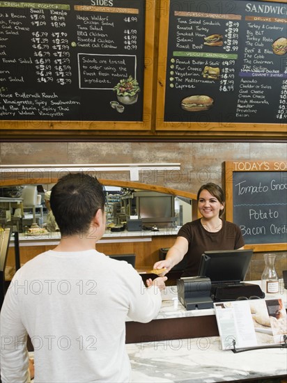 Customer paying for his bakery order.