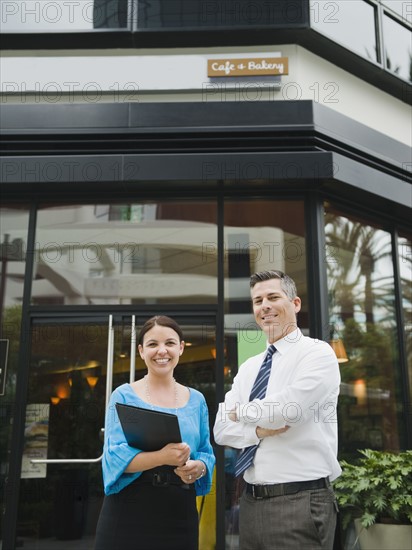 Business owners standing in front of building.