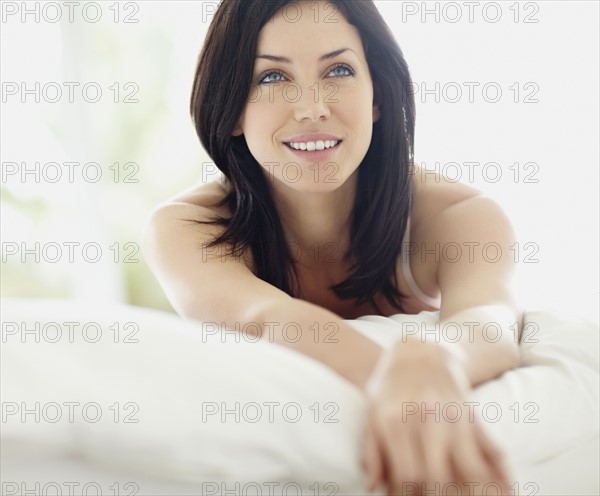 Sexy woman lying on bed. Photo. momentimages