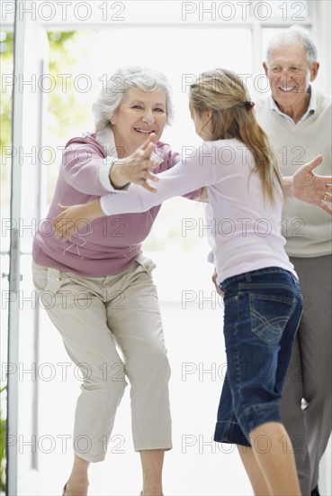 Granddaughter hugging her grandmother. Photo. momentimages