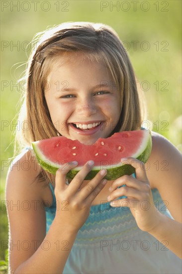 Young girl eating a slice of watermelon. Photo : Mike Kemp