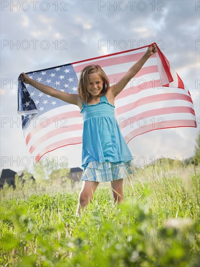 Young girl holding American flag. Photo. Mike Kemp