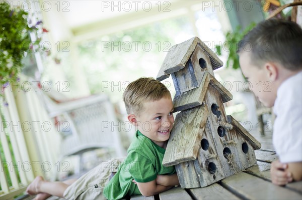 Young boys looking at birdhouse. Photo : Tim Pannell