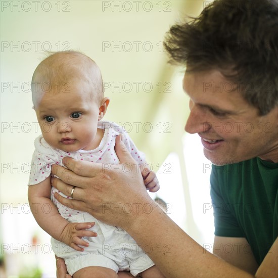 Father holding his baby daughter. Photo. Tim Pannell