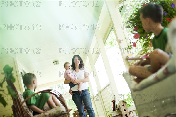 Family on porch. Photo : Tim Pannell