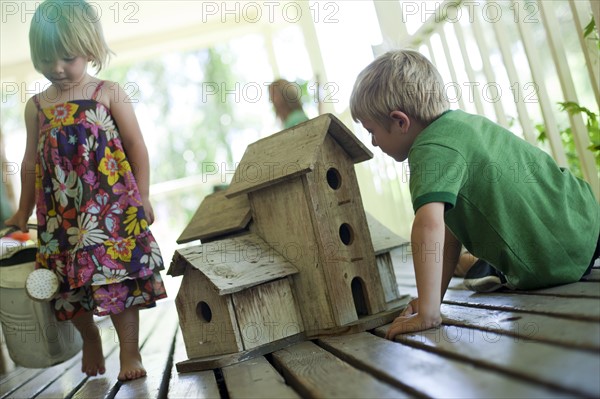 Brother and sister on porch. Photo : Tim Pannell