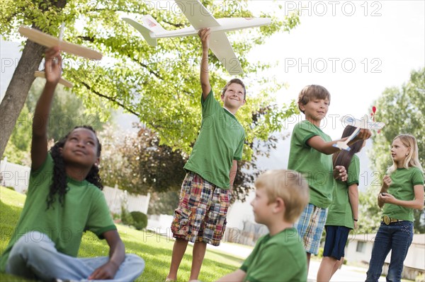 Group of children playing with toy airplanes. Photo : Tim Pannell