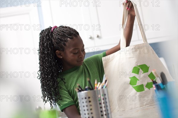 Young girl holding reusable shopping bag. Photo : Tim Pannell