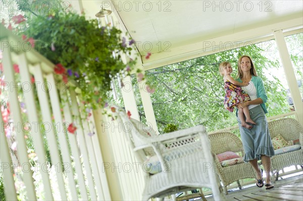 Mother walking on porch with her daughter. Photo. Tim Pannell
