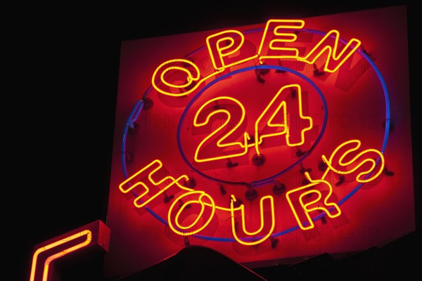 Illuminated open 24 hours sign. Photo : Antonio M. Rosario