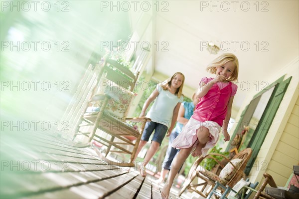 Children running on porch. Photo : Tim Pannell