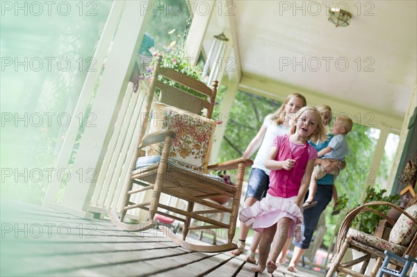 Family on porch. Photo : Tim Pannell