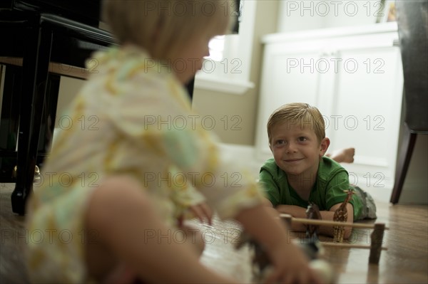 Brother and sister playing with toy animals. Photo : Tim Pannell