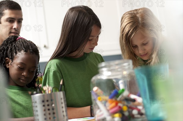 Group of children coloring. Photo : Tim Pannell