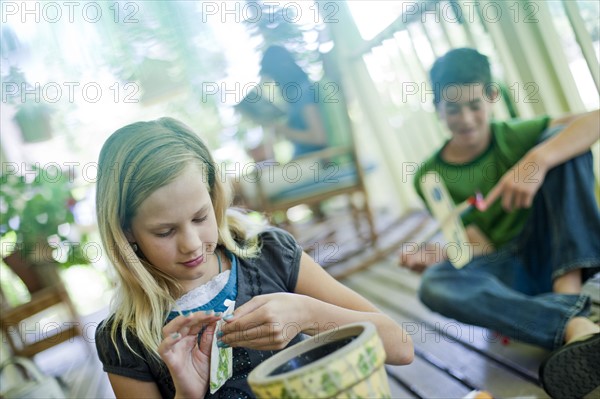 Young girl opening a seed packet. Photo : Tim Pannell