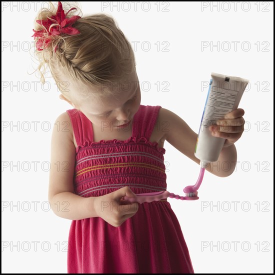 Cute young girl brushing her teeth. Photo. Mike Kemp