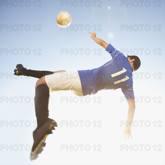 Soccer player jump kicking. Photo. Mike Kemp