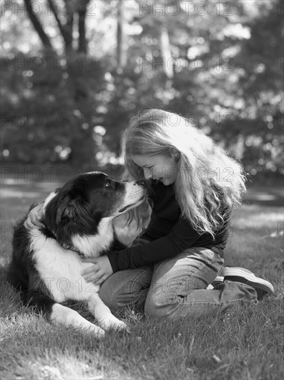 Young girl playing with dog. Photo : John Kelly