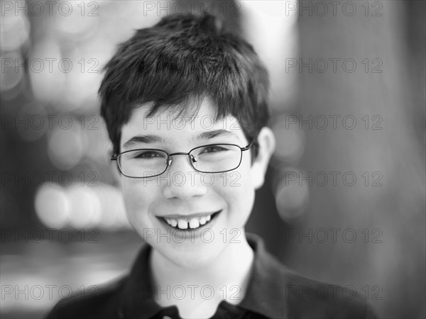 Cute child wearing reading glasses. Photo. John Kelly