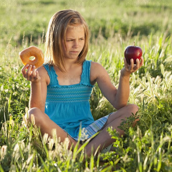 Young girl making food choice. Photo. Mike Kemp