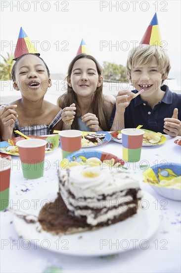 Children eating birthday cake. Photo. momentimages