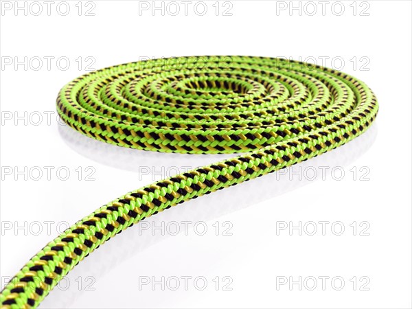 Green and black rope in a circular pattern. Photo. David Arky